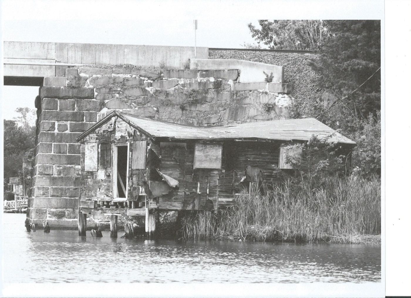 Close-up photograph of a collapsed shanty's brick and timber foundation